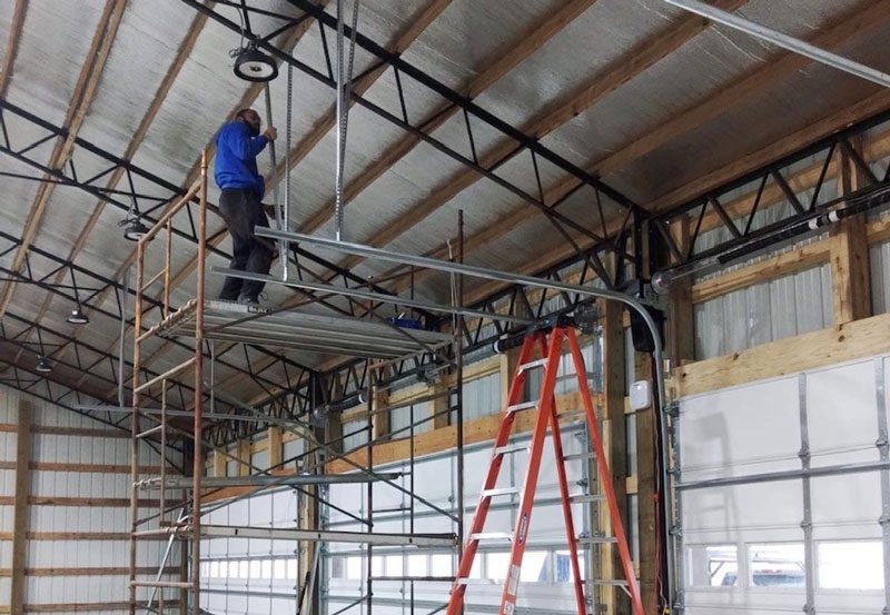 New garage door installation in Clarksville TN – professional installers working on large commercial garage doors
