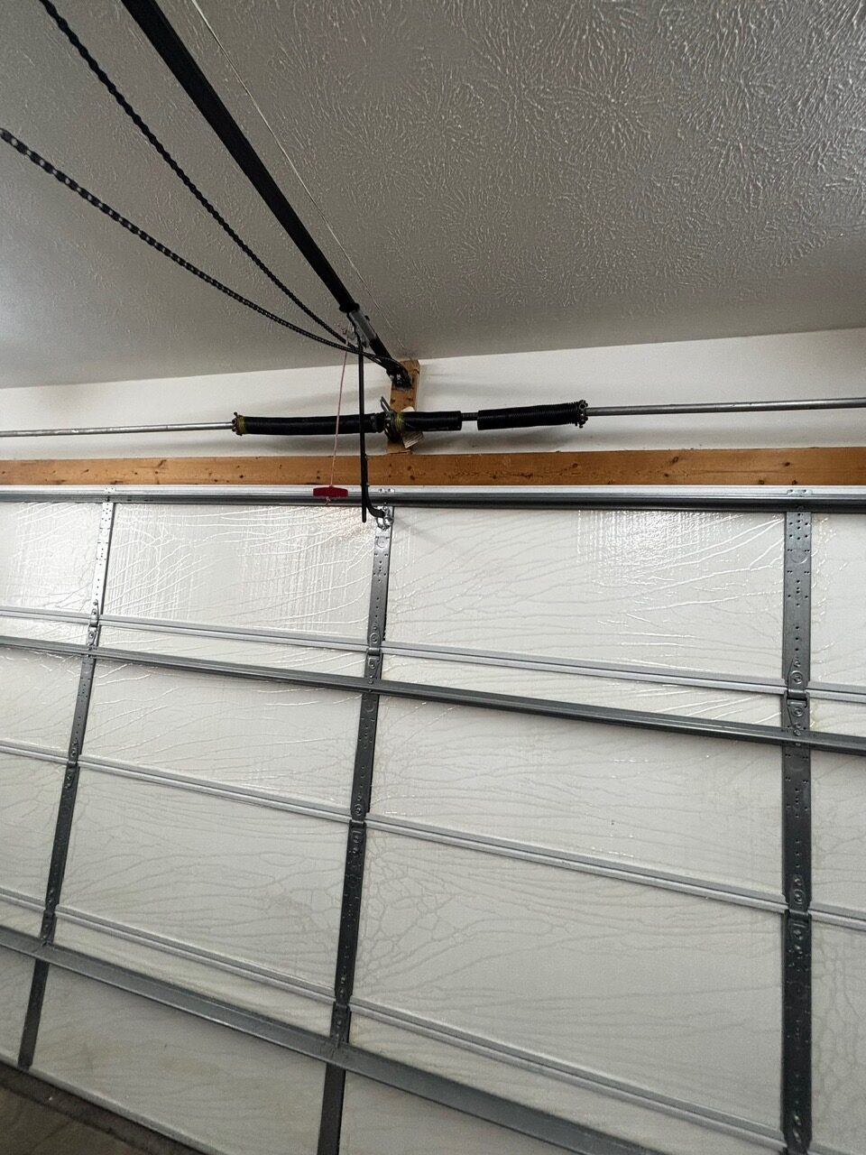 Broken garage door spring above door track – before broken spring replacement Clarksville TN